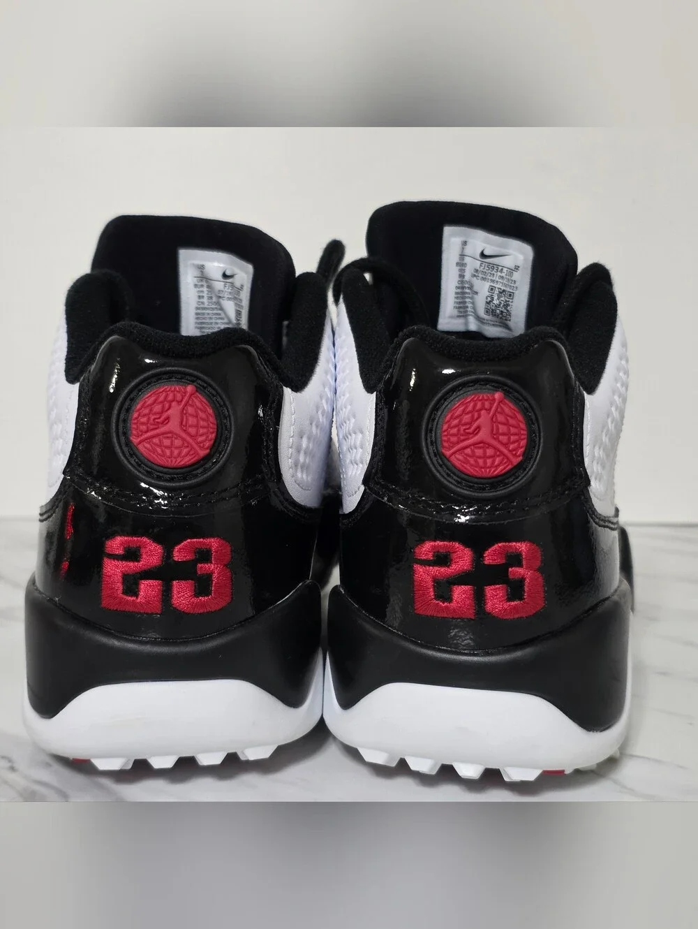 Jordan White and Black Golf Cleats with Red Logo